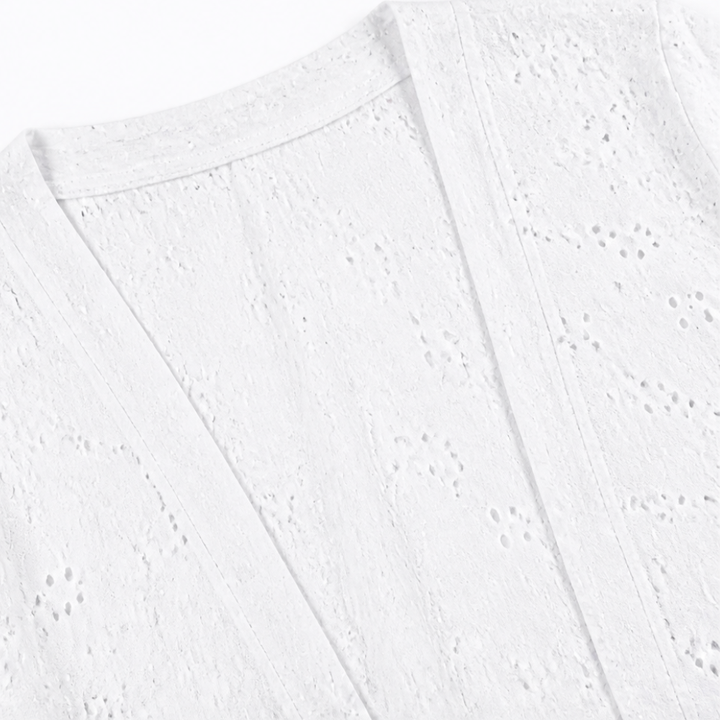 Open front placket on a white eyelet cardigan