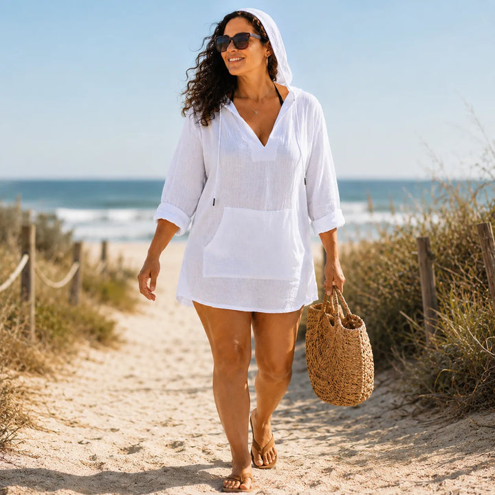 White lightweight hooded top worn as a beach cover up