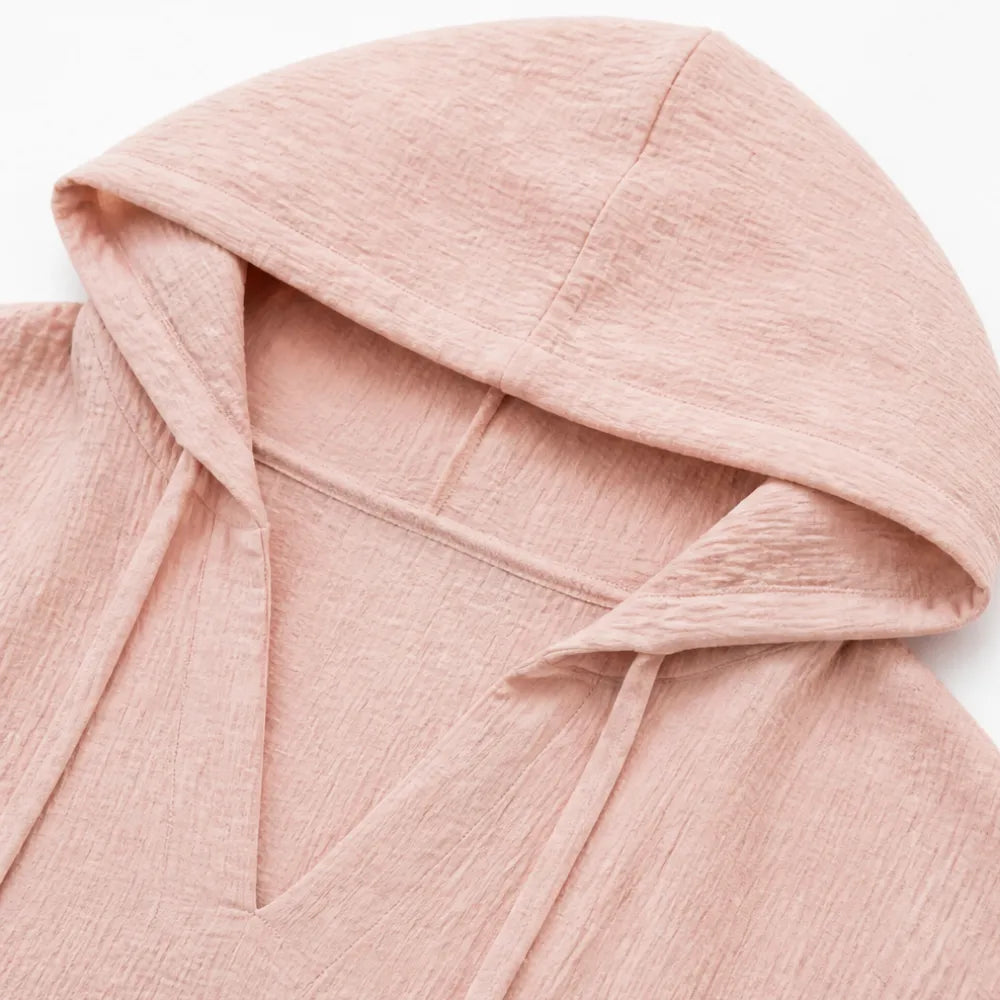 Close up of the hood and V neckline on a blush pink top