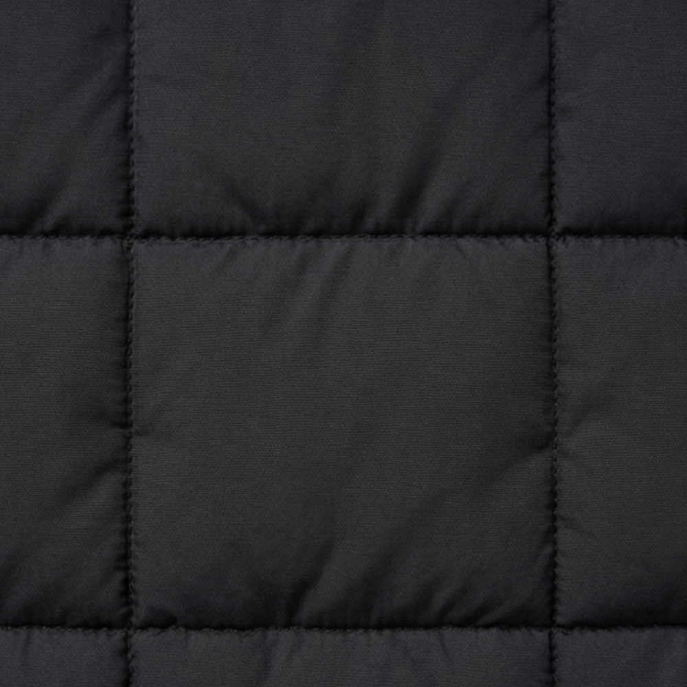 Close up of the box quilting on a black puffer vest
