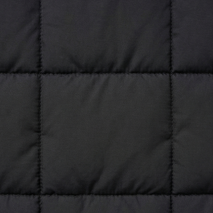Close up of the box quilting on a black puffer vest