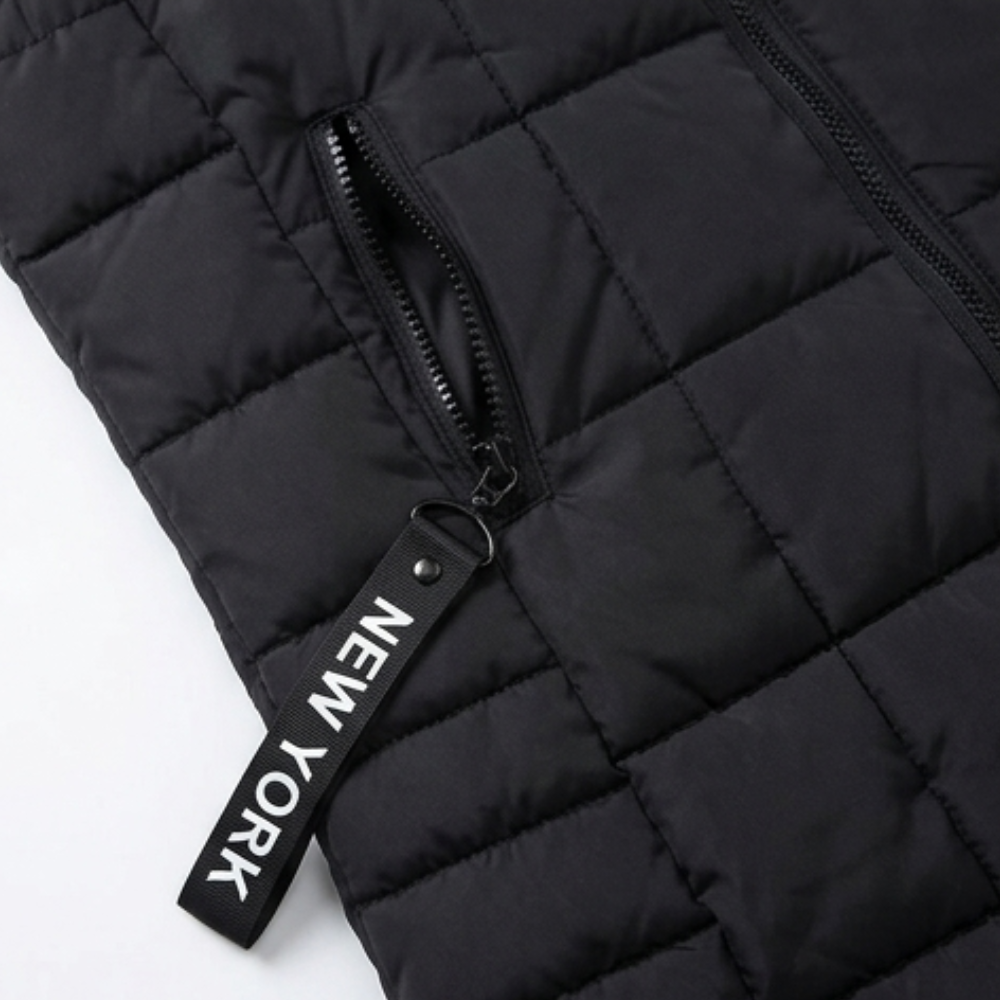 Close up of the zip pocket and box quilting on a black vest