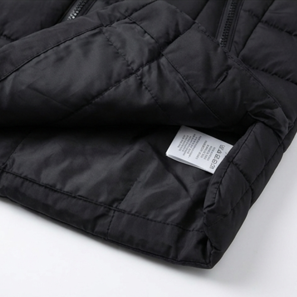 Folded black quilted puffer vest showing the inner lining