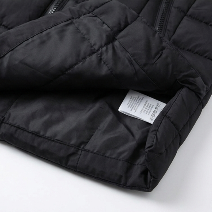 Folded black quilted puffer vest showing the inner lining