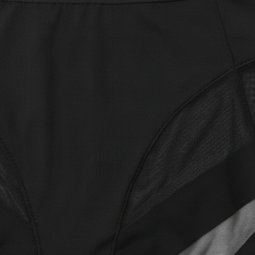 Close-up of the mesh panel seam on black briefs