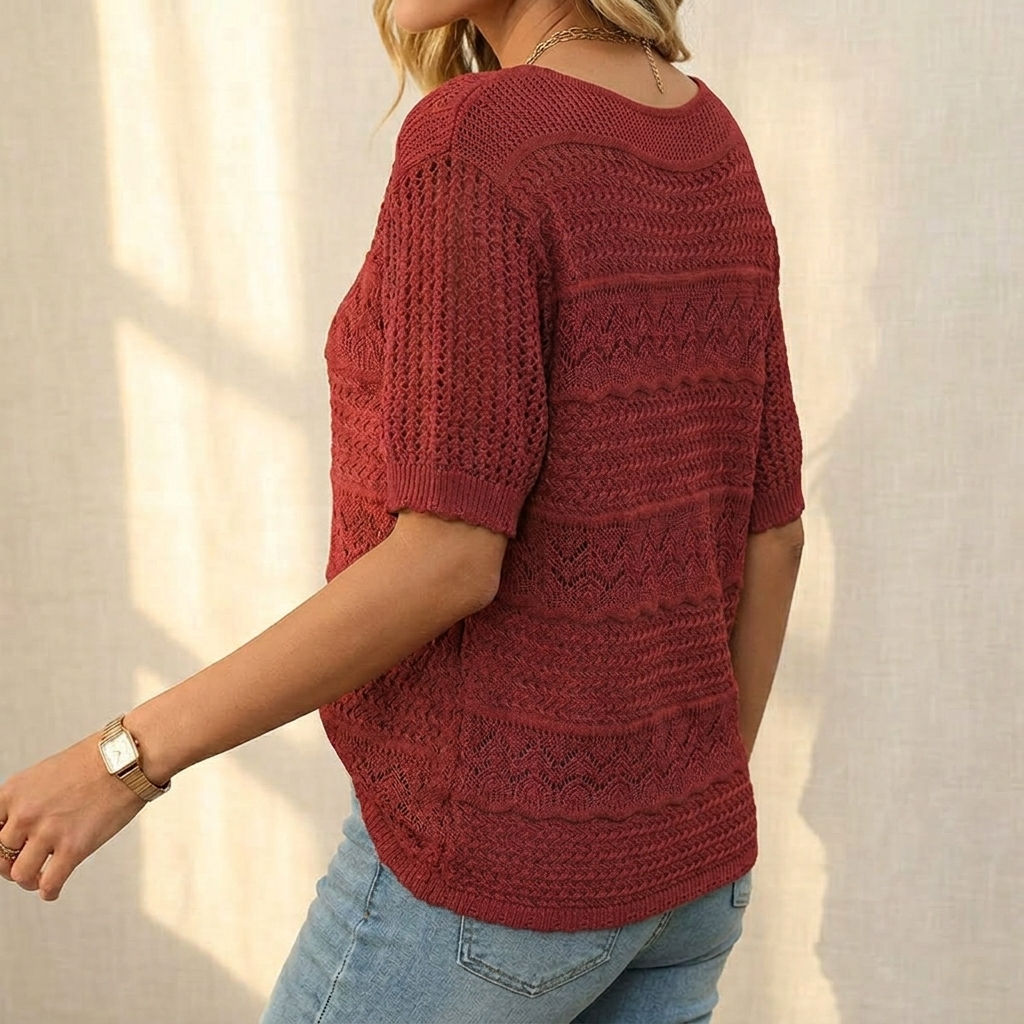 Side view of a burgundy openwork knit top worn with jeans