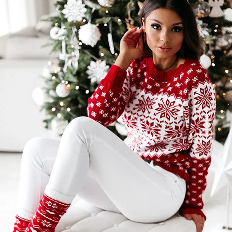 Red and white nordic snowflake knit sweater worn with white jeans