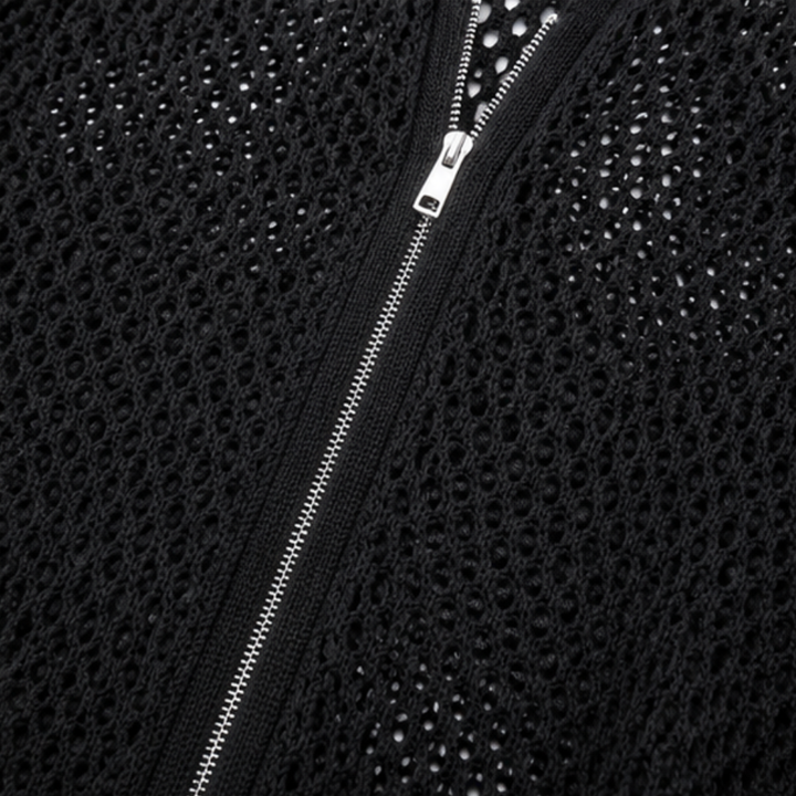 Close up of the silver zip on a black open knit cardigan