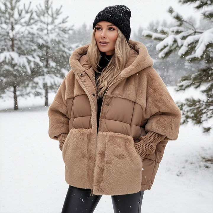 Camel quilted hooded jacket worn in the snow with leggings