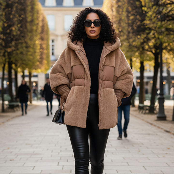 Woman on a tree lined avenue in a camel quilted hooded jacket