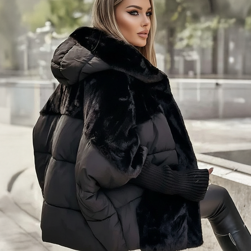Side view of a black oversized quilted hooded jacket
