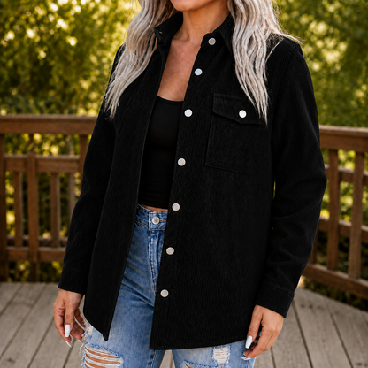 Black corduroy shirt jacket worn with ripped jeans on a deck