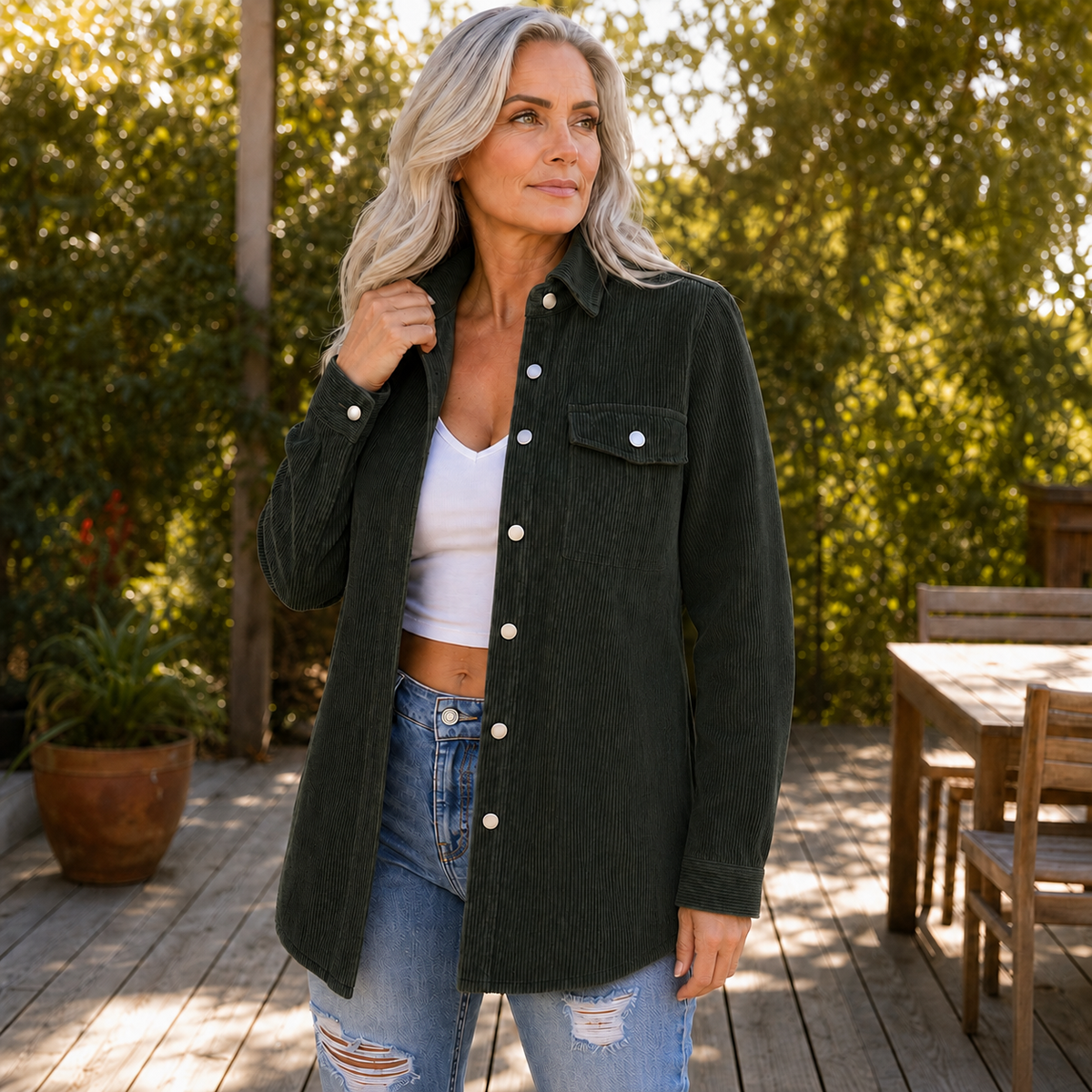 Dark green corduroy shirt jacket worn open with ripped jeans