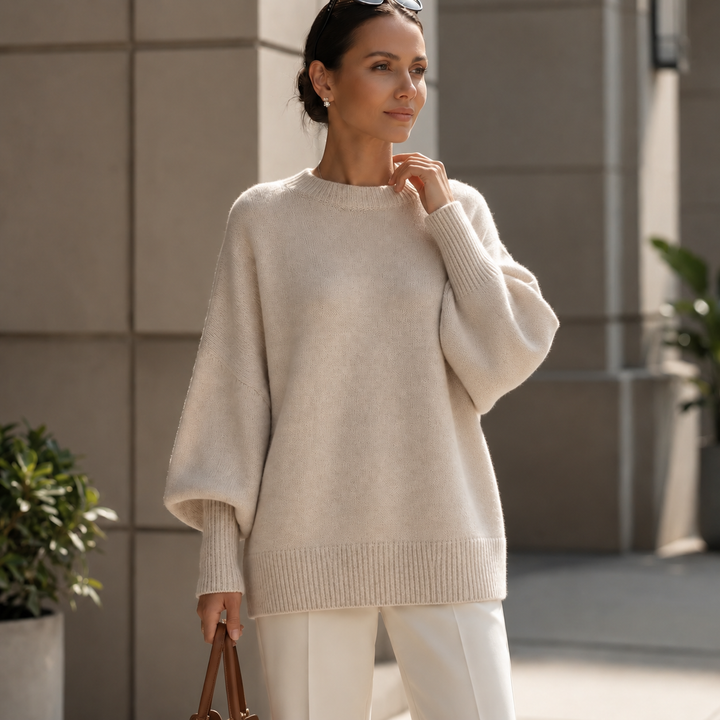 Cream oversized wool blend sweater with balloon sleeves and white trousers