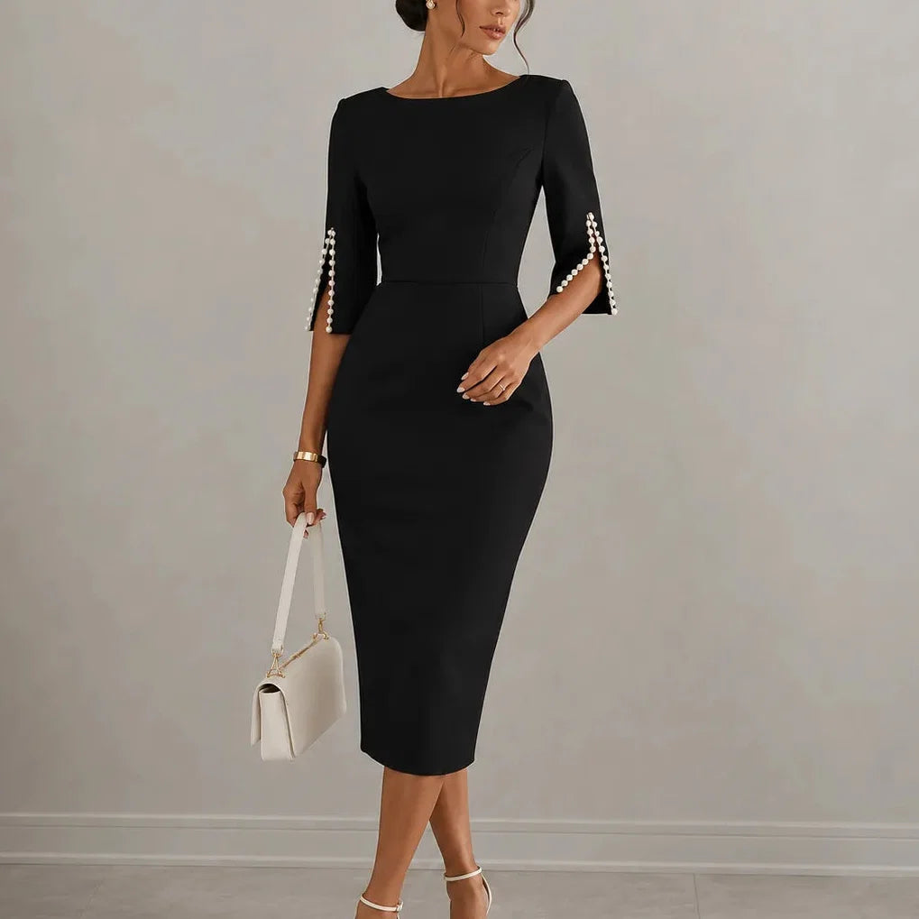 Black pencil midi dress with pearl trimmed split sleeves, worn with a cream shoulder bag, front view