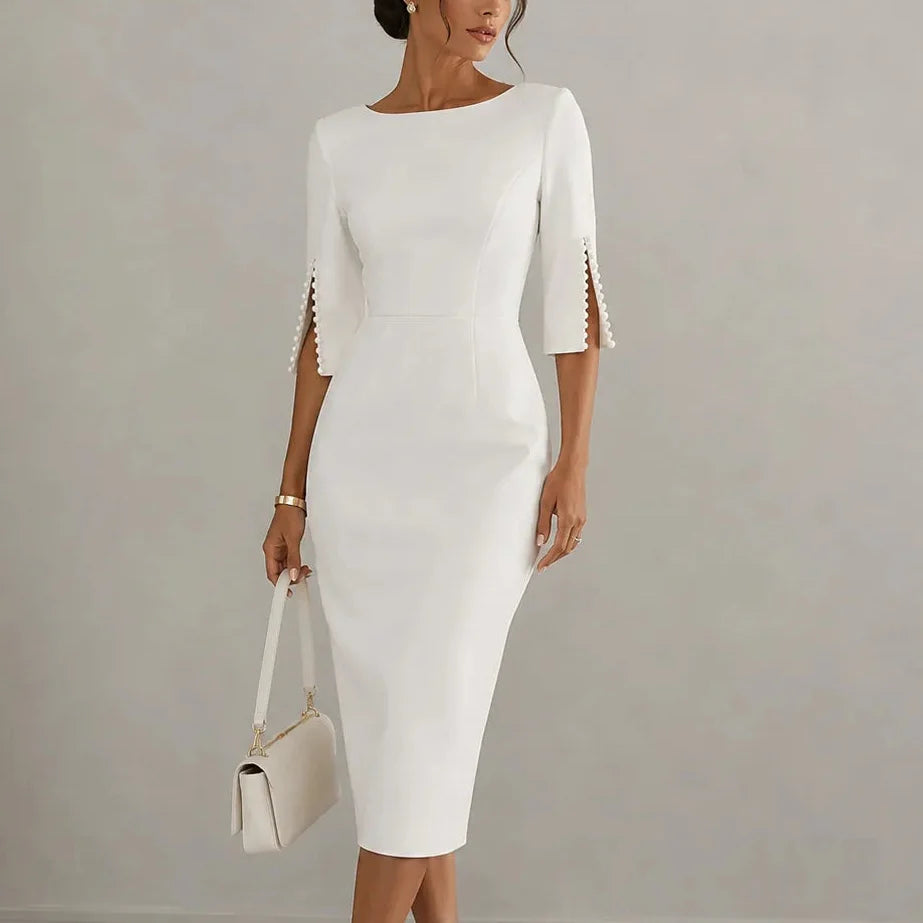 White pencil midi dress with pearl trimmed split sleeves, styled with a shoulder bag