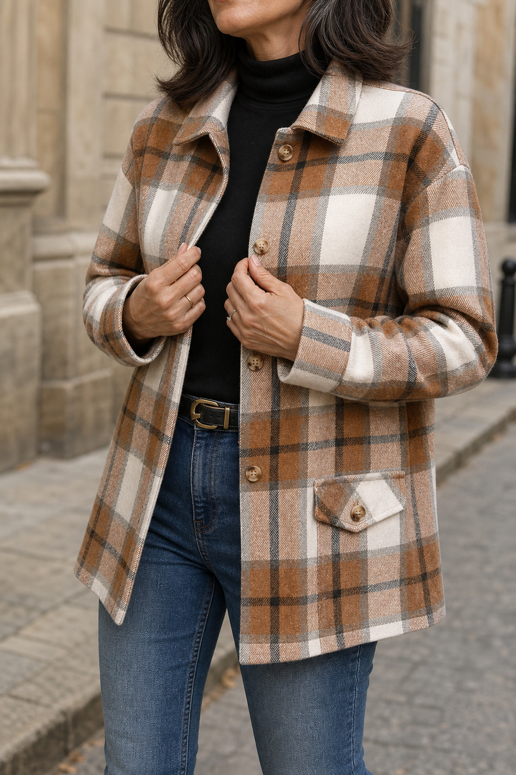 Camel plaid shirt jacket worn over a black top with jeans