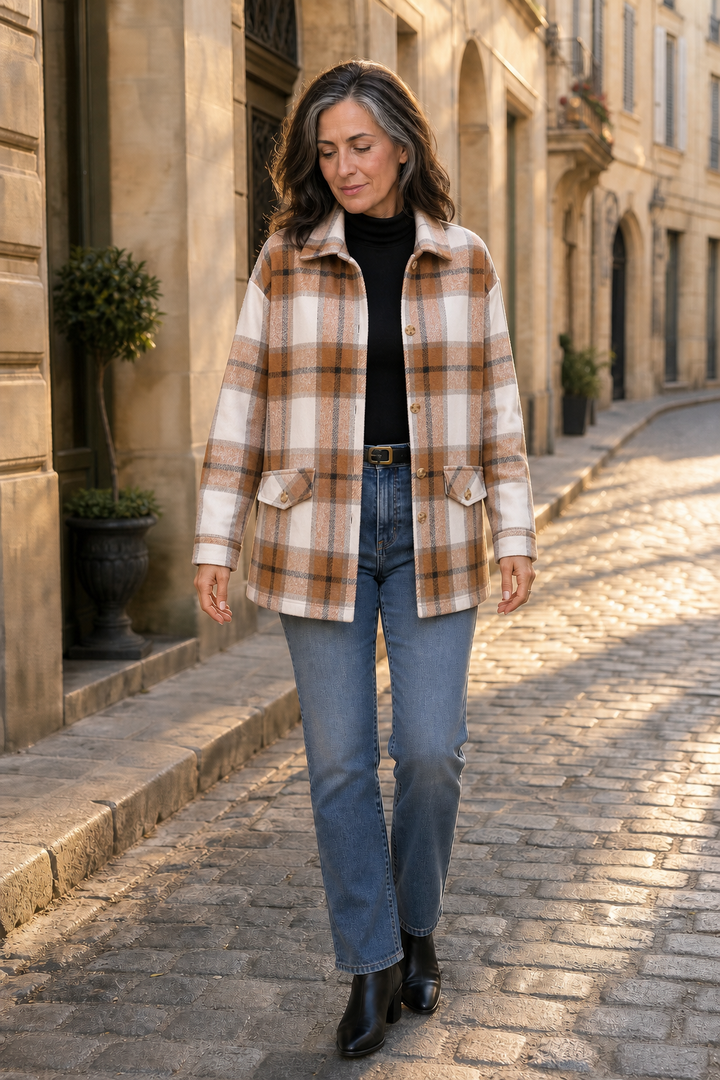 Camel plaid shirt jacket worn with jeans on a sunlit lane