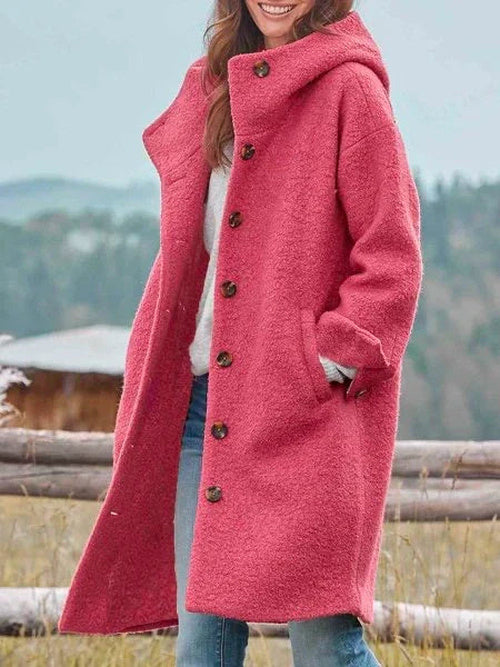 Pink plush fleece longline jacket with a hood worn over jeans