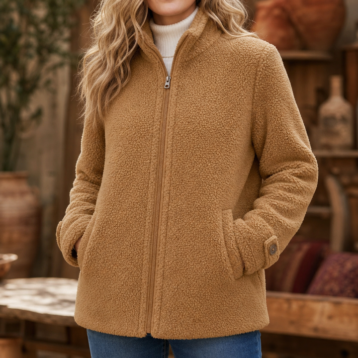 Camel plush fleece jacket zipped with hands in the pockets