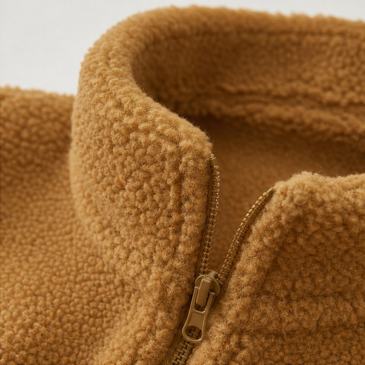 Close up of the stand collar and zip on a camel fleece jacket
