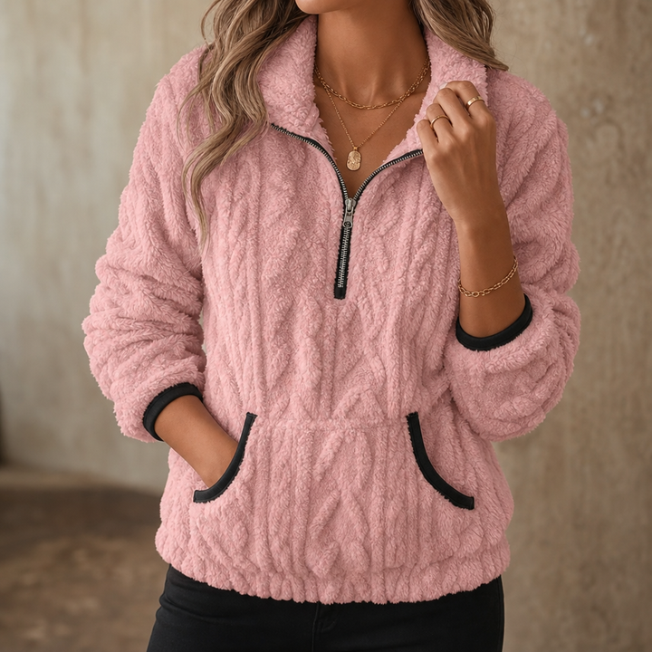 Pink plush fleece pullover worn with black leggings