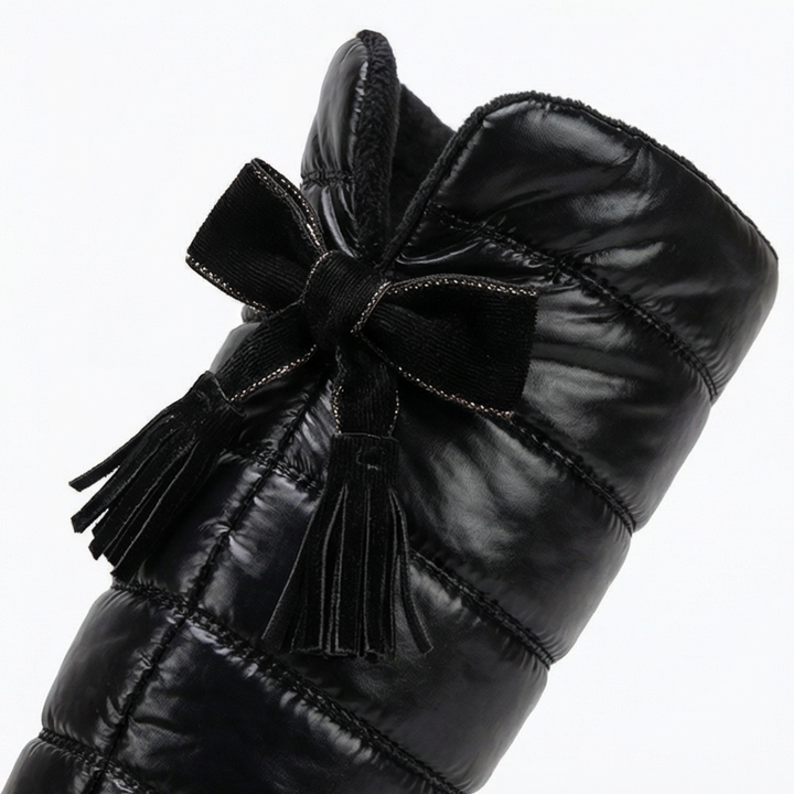 Velvet bow and tassel detail at the back of a quilted snow boot