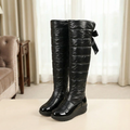 Black quilted over the knee snow boots with bow back detail