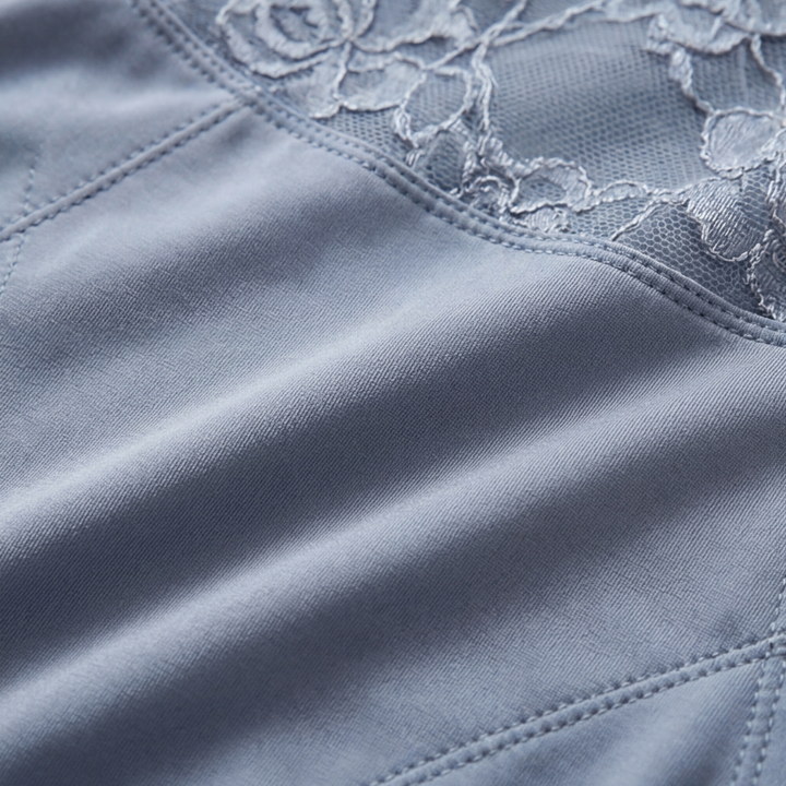 Close-up of the quilted seam joining lace to smooth fabric