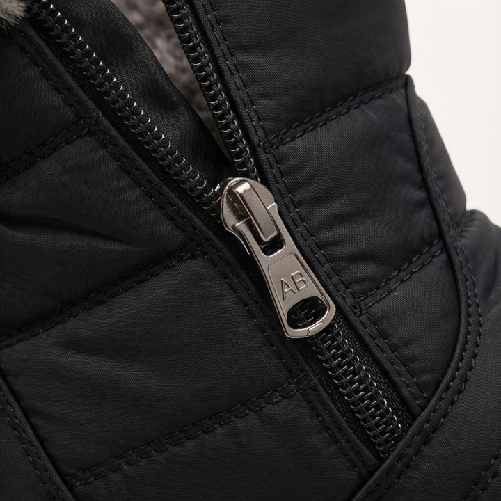 Side zip detail on a black quilted winter ankle boot
