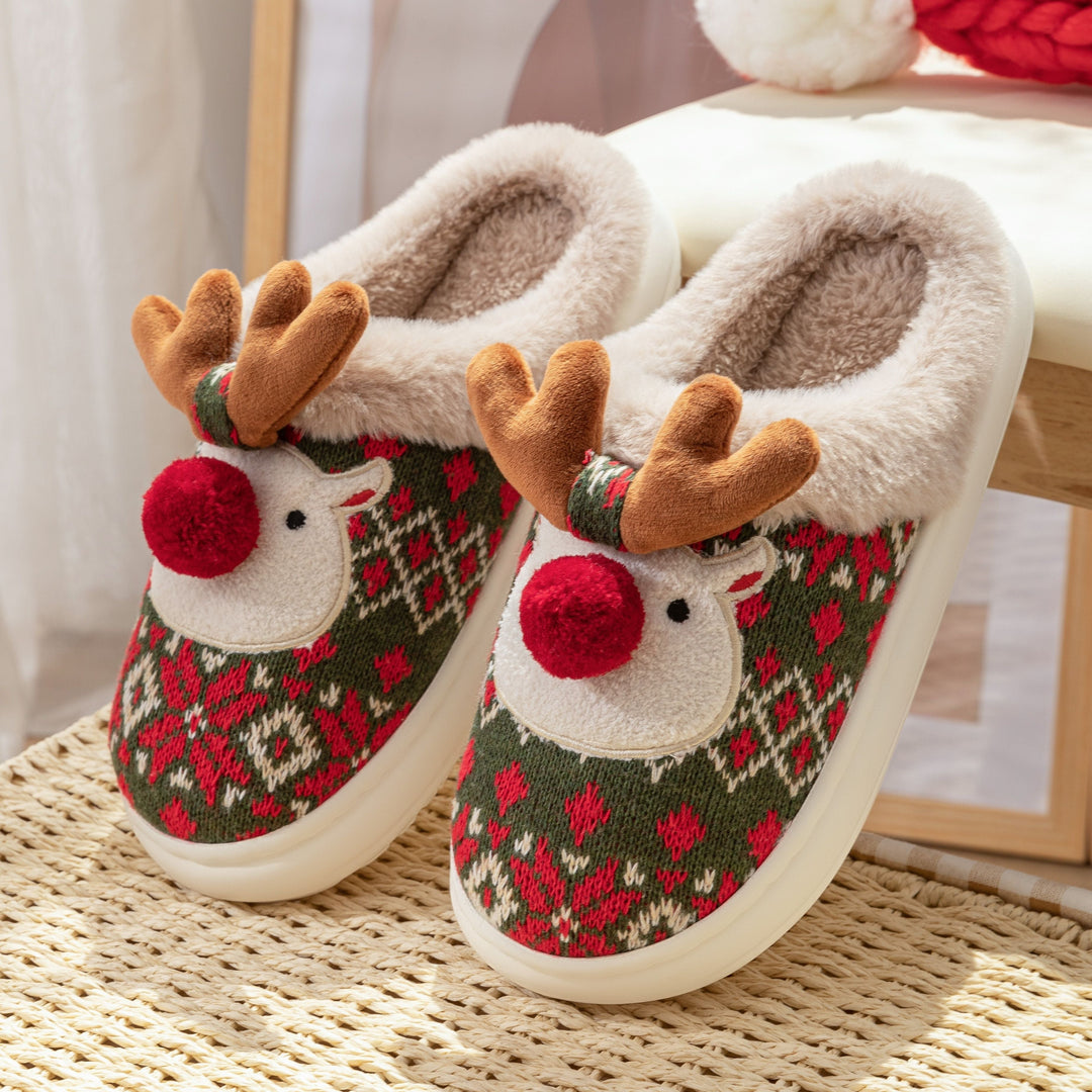 Green knitted reindeer slippers with plush antlers and red pom-pom nose, side view