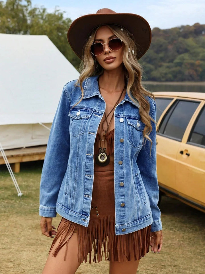 Light wash relaxed denim jacket worn with a hat and fringed skirt
