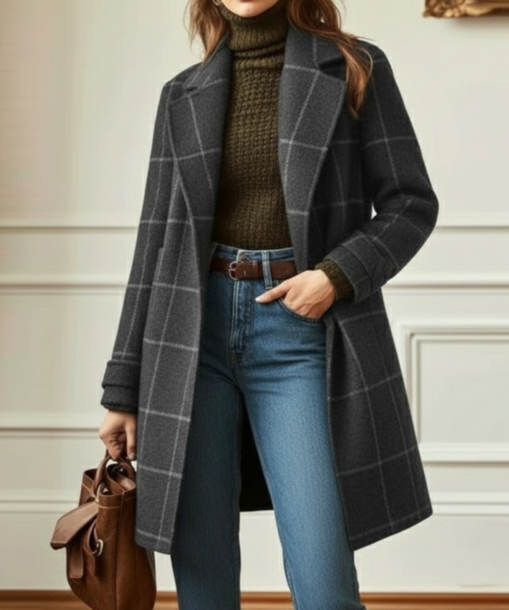 Grey windowpane check lapel coat worn over jeans with a tan bag