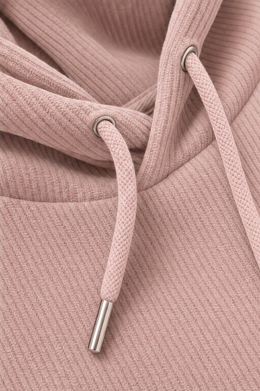 Drawstring and metal tip detail on a mauve ribbed hoodie
