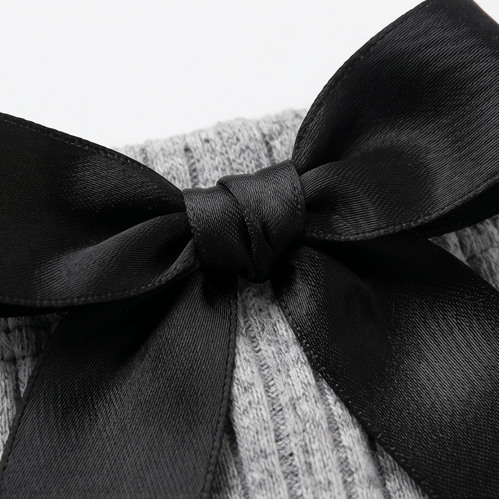 Close-up of the black satin bow on the grey cami