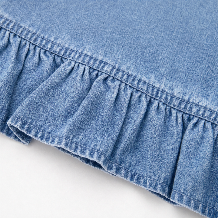 Gathered ruffle hem detail on a light wash denim cardigan