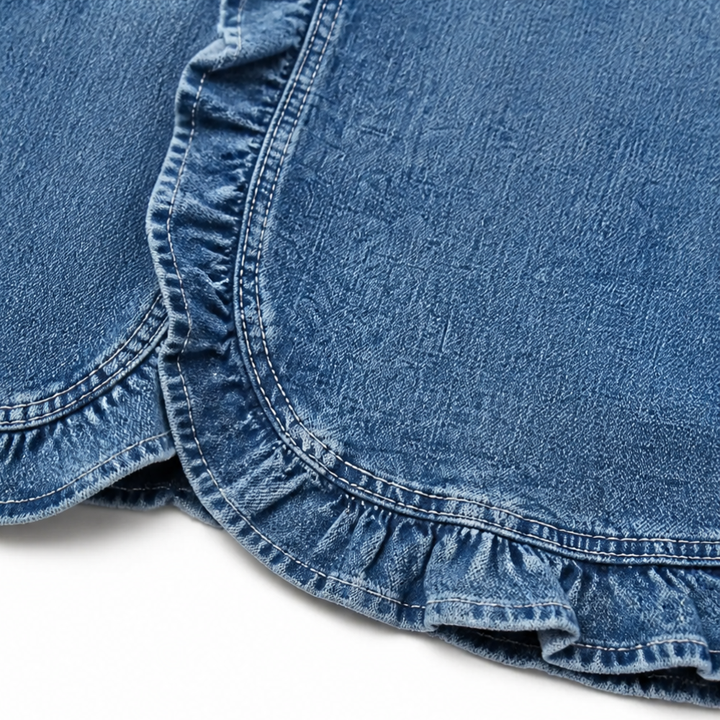 Ruffled curved hem detail on a blue denim jacket