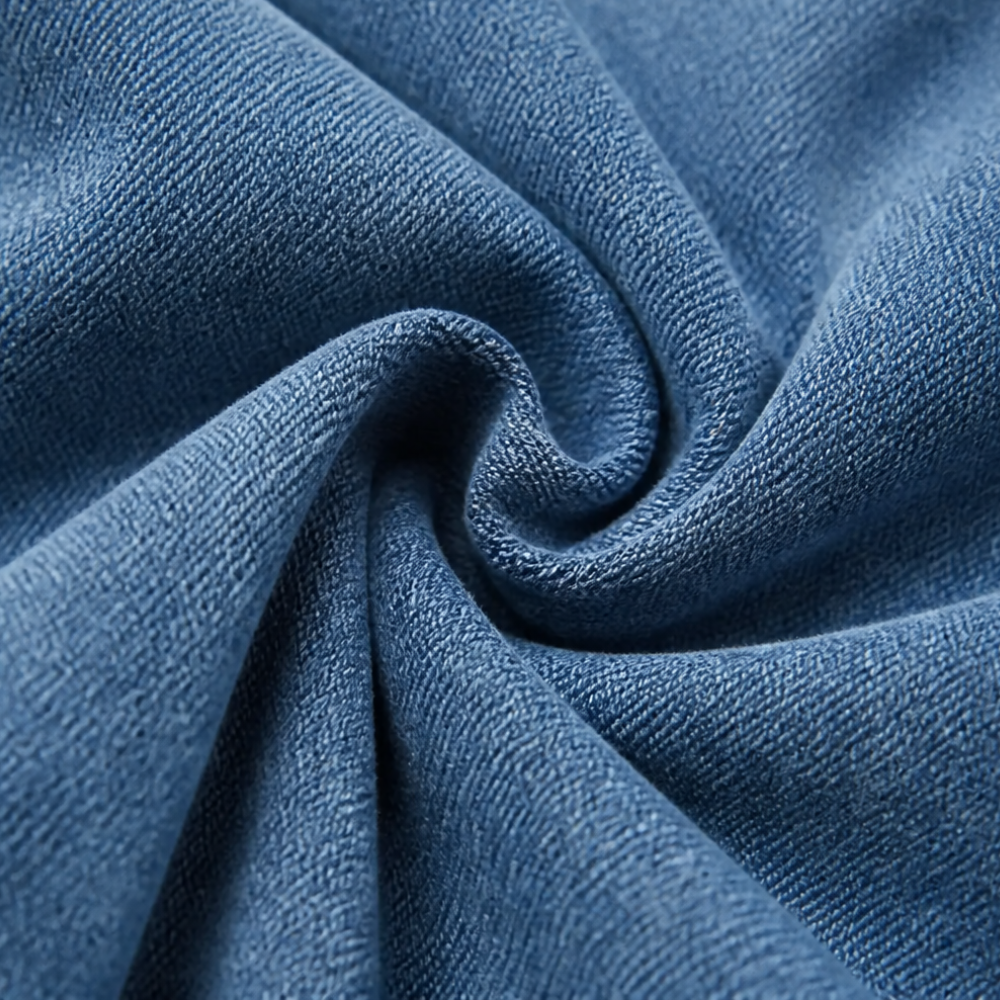 Close up of the soft blue denim fabric in folds