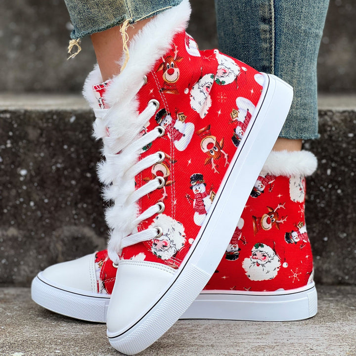 Red festive high top sneaker with fur trim, worn on a stone step