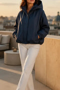 Navy hooded windbreaker with a balloon hem and elasticated cuffs