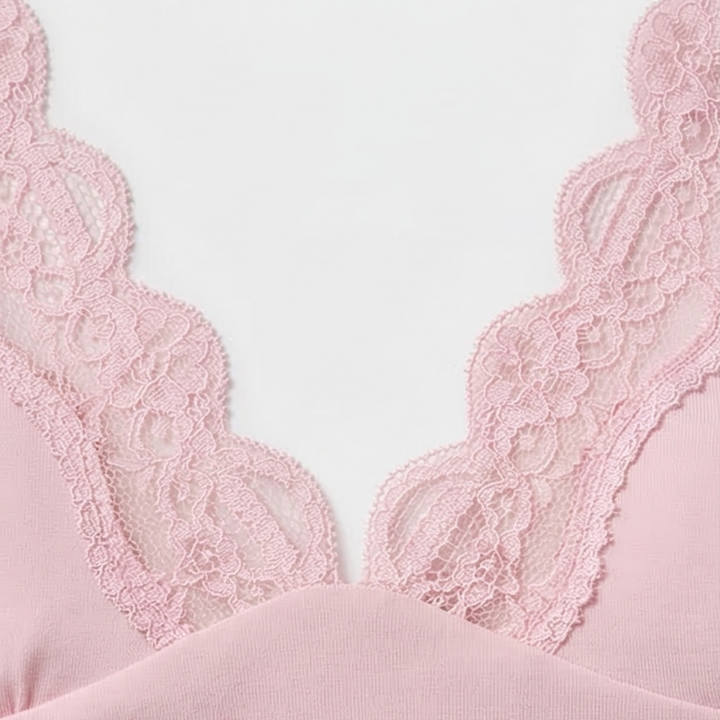 Close-up of the scalloped lace V neckline in pink