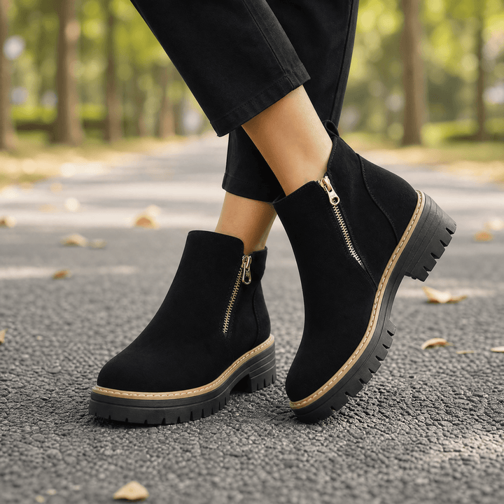 Black suede chelsea boots with side zips and lug soles