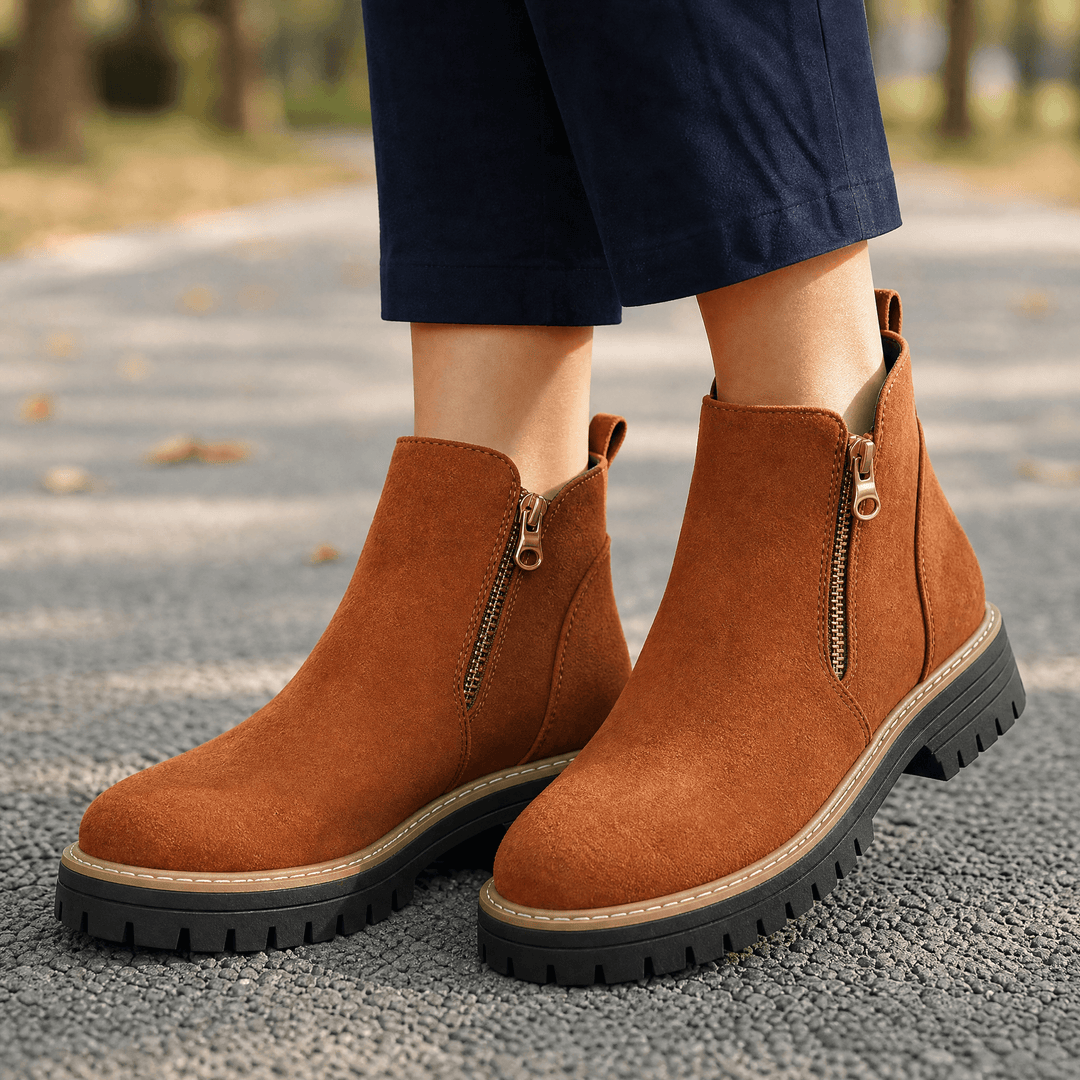 Tan suede chelsea boots with gold side zips and lug soles