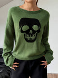 Green crew neck knit sweater with a large black skull graphic on the front