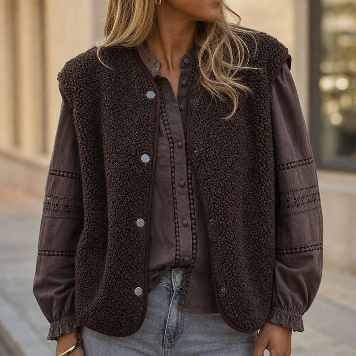 Brown teddy fleece vest worn over a brown blouse with jeans