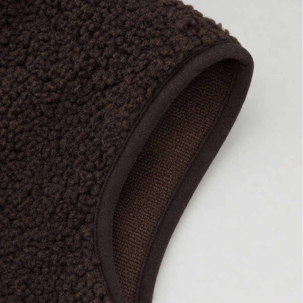 Bound armhole edge on a brown teddy fleece vest