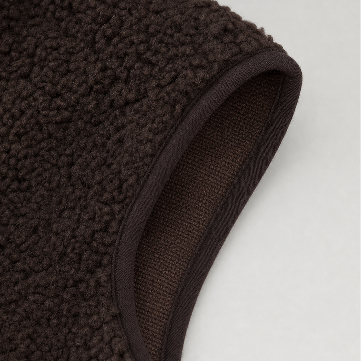 Bound armhole edge on a brown teddy fleece vest