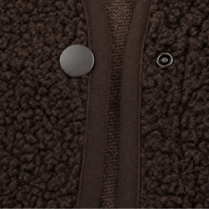 Press stud closure on a brown teddy fleece vest