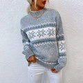 Blue marl knit sweater with a white snowflake band across the chest