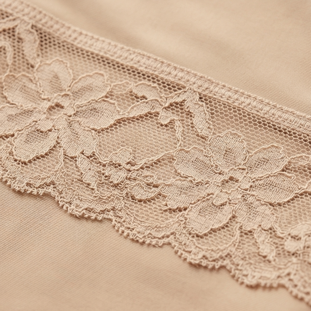 Close-up of the floral lace leg trim on a nude shaper